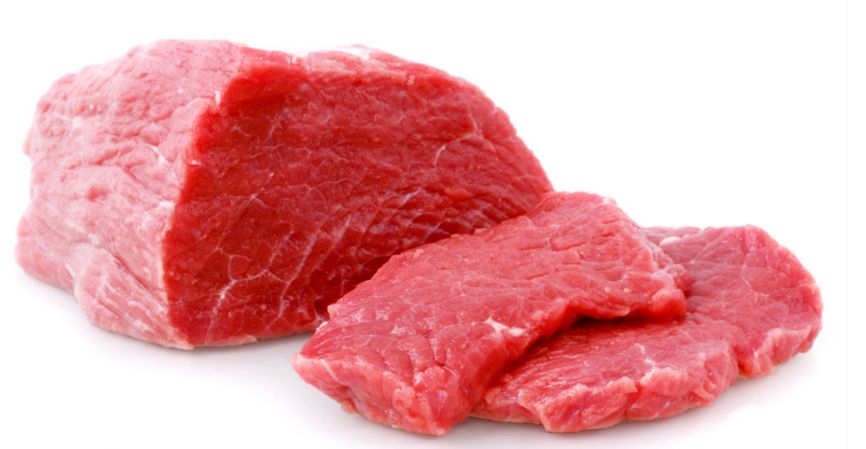Check weigher weighing trays of fresh meat in a food plant